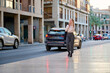 © Cavan Images - Businesswoman walking and talking on the phone in a vibrant city