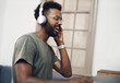 © peopleimages.com - Business, headphones and man in office, listening to music and audio for motivation. Graphic designer, sound engineer and employee for creative agency, headset and playlist with song, sing or podcast