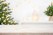 © didecs - Front view of Christmas table top with blurred fir tree and winter holiday decoration background