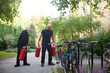 © Johnér - Bicycles parked near couple carrying fire extinguisher on footpath in garden
