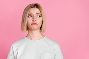 Photo of pretty young woman look empty space wear t-shirt isolated on pink color background