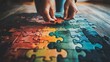 © Andrew - The Final Piece: Hands carefully placing the last puzzle piece, completing a vibrant, colorful jigsaw puzzle on a rustic wooden surface. A visual metaphor for problem-solving, collaboration.