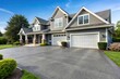 © Atittaya - Gray walled suburban house with white asphalt driveway Forced Perspective