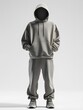 © Akash - Model man in a trendy hoodie with joggers on a white background.