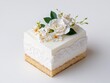 © Thi - Moist and decadent wedding cake slice adorned with elegant lace detailing and delicate sugar flowers.