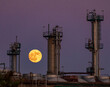 © ADDICTIVE STOCK - Full moon rising over industrial Porto skyline