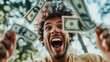 © AndreyFrol - A young man with an expressive face, experiencing intense joy. He smiles widely and is probably laughing as he holds the money in his hands.