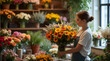 © Sabina Rasulova - A florist arranges a bouquet of sunflowers and dead branches. Florist shop with different varieties of flowers and plants. The florist arranges a bouquet.