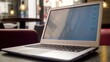 © Iswanto - A laptop sits on a table in a caf?, showcasing a blank screen and minimal design.