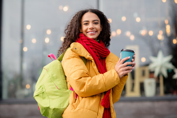 Photo of charming cute girl wear jacket walk downtown drink hot cacao weekend cold autumn day outdoors outside