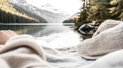 Sticker - A serene lakeside view with cozy blankets and nature in the background.