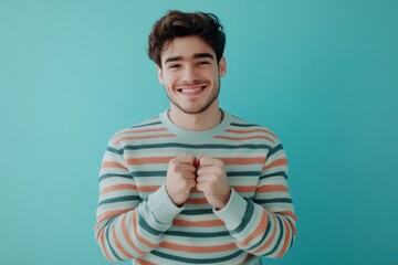 Wall Mural - A happy man wearing a striped shirt and smiling at the camera