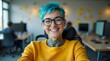 © Unslux - portrait inclusive happy smiling American disabled office LGBTQ+ female wheelchair bound colleague, blue lesbian hair, bright diverse deib positive soft blurred workplace candid