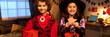 © pressmaster - Banner of cheerful cute kids in Halloween outfit of demon and witch holding pumpkin buckets with treats and looking at camera