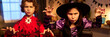 © pressmaster - Header of youthful kids in Halloween costumes of witch and demon scowling and clawing while looking at camera in dimly lit room