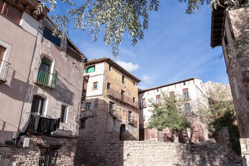 Wall Mural - Charming traditional houses in a rustic Spanish village under a bright blue sky