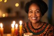 © Larisa - Smiling woman with lit Kwanzaa candles in warm light.