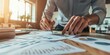 © kwanchaift - An entrepreneur reviews business insurance policies in a modern workspace, focusing on future success and security.