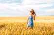 © Константин Плотников - Russia, Republic of Tatarstan, Kalmash village, August 01, 2024, 17:00, girl in a dress in a wheat field in summer