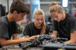 © Mselected - Three students collaborate on a robotics project in a workshop during afternoon hours