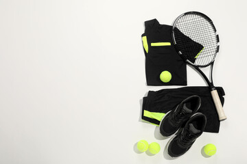 Canvas Print - Tennis racket, balls and sportswear on white background, flat lay. Space for text