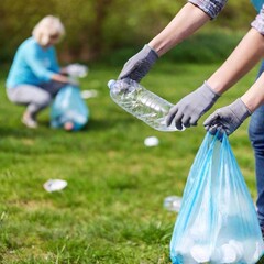 extreme macro photo of volunteers with picking up trash at earth day, seen in soft focus. no text is