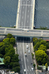 Aerial view of two intersecting highways with a bridge over the river in Tokyo, Japan creates a crossroads of streets