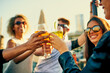 © peopleimages.com - People, hands and cheers with drinks in glass for outdoor, celebration and vacation together. Happy, holiday and group of friends with alcohol in toast for adventure, party and New Years gathering