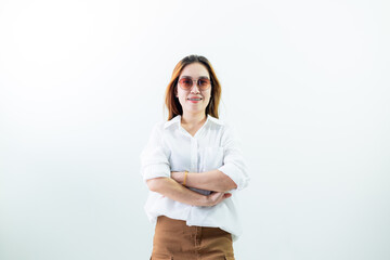 Young Asian woman sitting on isolated chair on white background. Studio shot of beautiful long haired Asian female model in white long sleeve shirt and casual shoes