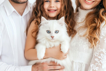 Happy family holding adorable white kitten at home