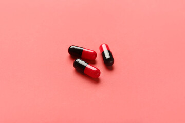 Wall Mural - Medical capsules on red background