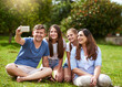 © peopleimages.com - Parents, children and smile for selfie in park with bonding, happy memory or relax on grass for holiday. Family, people and photography in nature for social media post, profile picture update or love