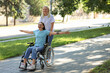 © Pixel-Shot - Young woman in wheelchair and her mother spending time together outdoors