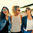 © peopleimages.com - Outdoor, women and happy with travel in summer for bonding, vacation or weekend trip together. Relax, smile and female friends with sunglasses in sunshine for adventure, journey or reunion on holiday