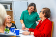 © unai - Tender nurse giving medication to a senior women at geriatrics