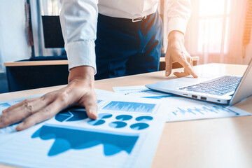 Wall Mural - Businessman accountant or financial expert analyze business report graph and finance chart at corporate office. Concept of finance economy, banking business and stock market research. uds