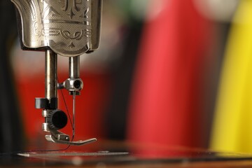 Canvas Print - One vintage sewing machine on blurred background, macro view. Space for text