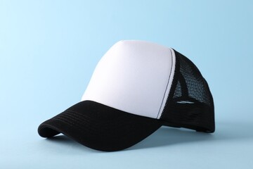 Poster - Stylish baseball cap on light blue background. Mockup for design