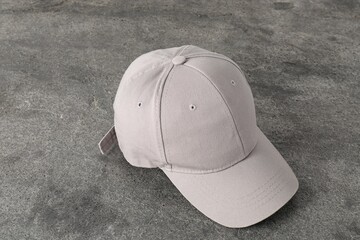 Poster - Stylish baseball cap on grey textured surface. Mockup for design