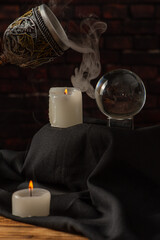 Lighted candles, scene with various objects and recently extinguished candles. Selective focus.