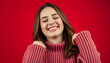 © Sergey - Pretty overjoyed lady with closed eyes touching soft knitted jumper isolated on red background isolated with white highlights, png
