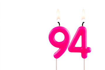 Pink number 94 birthday candle on white background