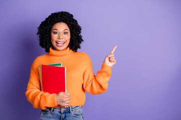 Photo of shiny attractive lady dressed knitted pullover holding book pointing empty space isolated purple color background