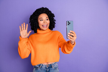 Photo of shiny attractive lady dressed knitted pullover recording video modern gadget waving arm empty space isolated purple color background