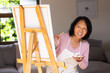 © Wavebreak Media - asian senior woman painting on canvas at home, smiling and enjoying creativity