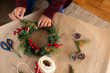 © Wavebreak Media - Asian senior woman rafting festive wreath with pine cones and berries at home for christmas