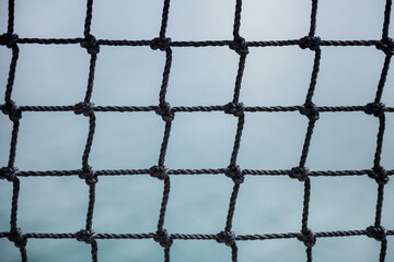 Black rope net with water as background