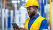 © Marketplace - A focused worker in a yellow hard hat and safety glasses checks a smartphone in a modern industrial setting, showcasing safety and technology.