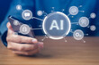 © Kitinut - Digital communication,Chat bot,Futuristic amd innovation.Businessman using mobile phone with AI robotic technology icons screen.