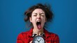 © Sanchat - Woman screaming with alarm clock in hands, blue background.